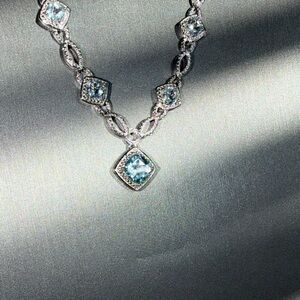 Blue topaz with white diamond accents necklace